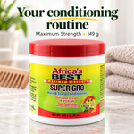 A jar of Africa's Best Super Gro Hair & Scalp Conditioner with a red lid and yellow-to-green label, placed on a marble surface with a comb and folded towels in the background. Large text at the top reads 'Your conditioning routine Maximum Strength 149 g'.