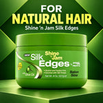 A green jar of Shine 'n Jam Silk Edges hair product centered on a green geometric background, with large text above reading 'FOR NATURAL HAIR' and 'Shine 'n Jam Silk Edges.' Visible product branding includes 'Silk Edges' and 'amga PRO STY.