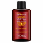 Creme Nature Argan Oil Treatment bottle in a dark reddish-brown color with a black cap, featuring a red label with gold and white text.