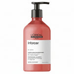 L'Oréal Professionnel Paris Inforcer BB + Biotin Professional Shampoo in a translucent coral pink bottle with a black pump dispenser and a white label.