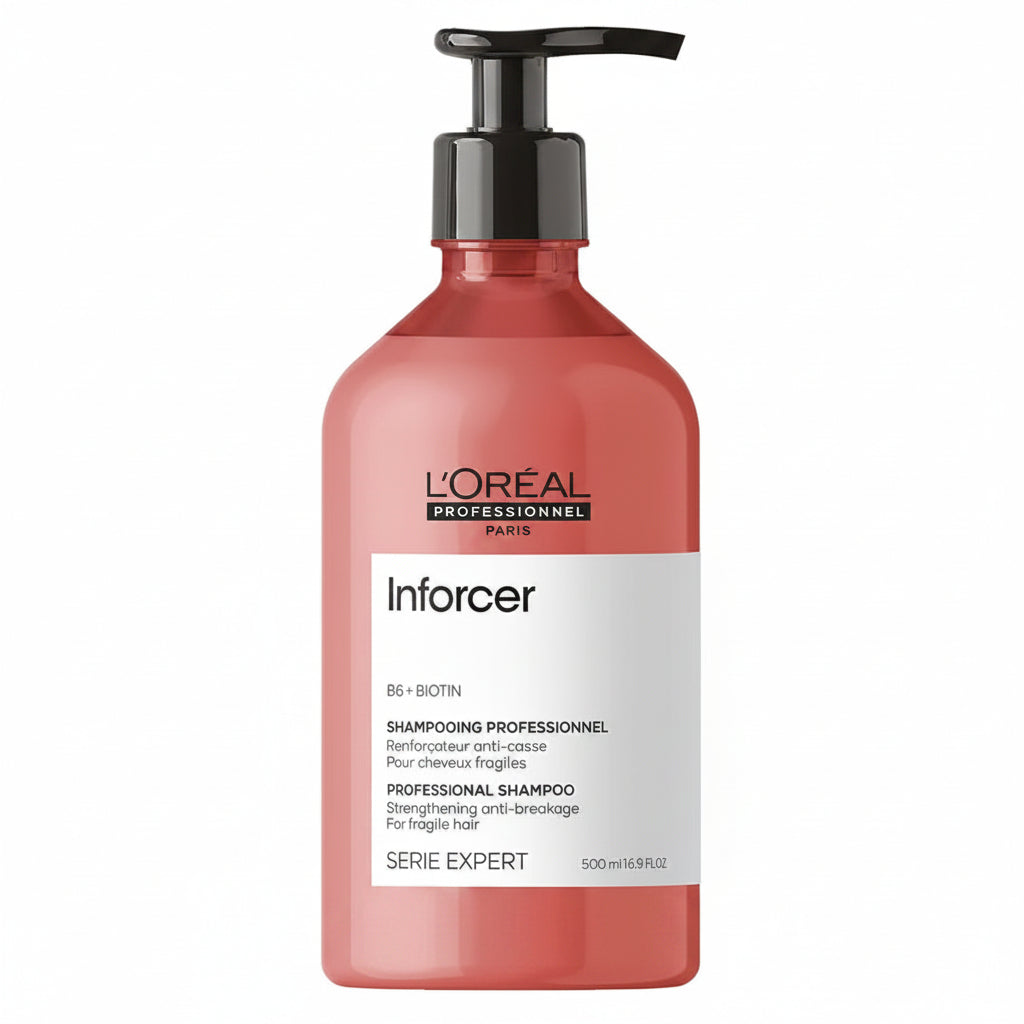 L'Oréal Professionnel Paris Inforcer BB + Biotin Professional Shampoo in a translucent coral pink bottle with a black pump dispenser and a white label.