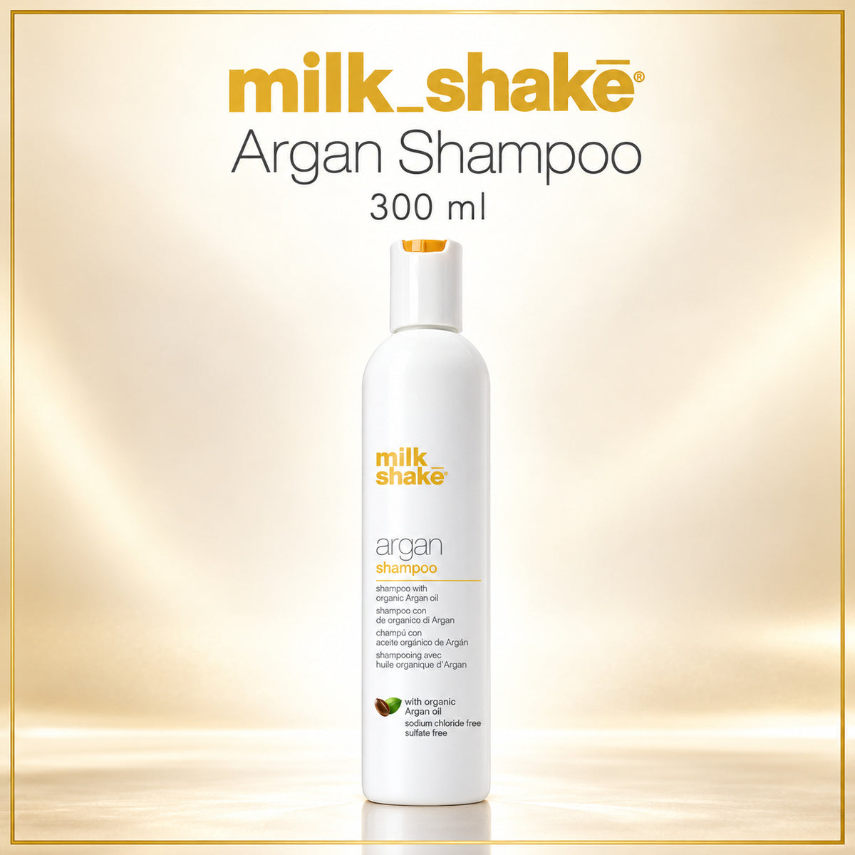 A 300 ml bottle of milk shake Argan Shampoo centered on a warm beige gradient background with a thin gold border. The bottle is white with orange and black text, and the brand name 'milk shake' is displayed prominently at the top.