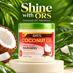 A jar of ORS Coconut Oil Hairdress placed on a white pedestal with tropical green leaves and coconuts in the background. Large text at the top reads 'Shine with ORS Coconut Oil Hairdress.
