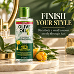 A bottle of ORS Olive Oil Glossing Hair Polisher stands on a marble tray in a bathroom-like setting with greenery and gold-toned accessories. Large text reads 'FINISH YOUR STYLE' and 'Distribute a small amount evenly through hair.