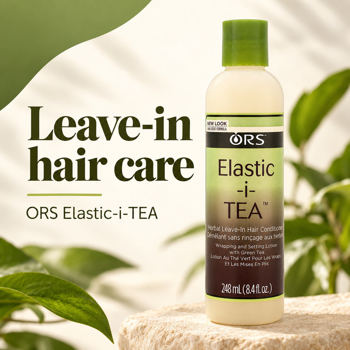 A bottle of ORS Elastic-i-TEA leave-in hair conditioner stands on a stone surface with large green leaves and a soft cream background. The bottle is off-white with a green cap and a green-to-brown label.
