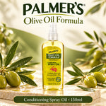 A bottle of Palmer's Olive Oil Formula Conditioning Spray Oil, 150ml, displayed on a stone slab with fresh olives and olive branches in a warm, natural setting.