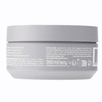 Back view of a gray hair product container with label details on a white background