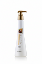 White bottle with gold pump labeled 'almond milk oil' on a white background