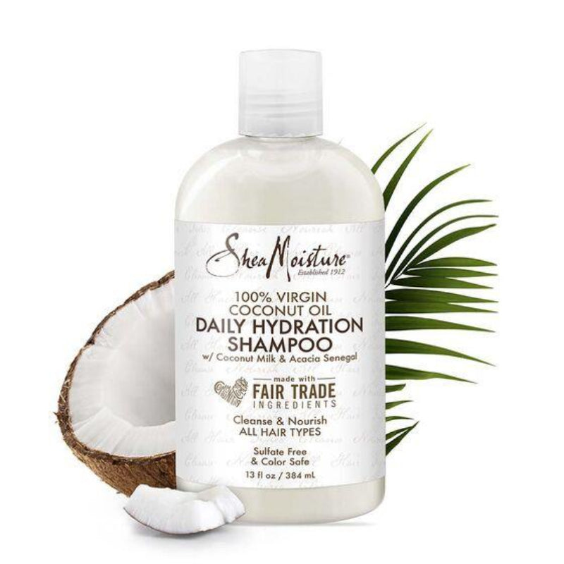 SheaMoisture coconut oil shampoo bottle with a coconut and palm leaf on a white background